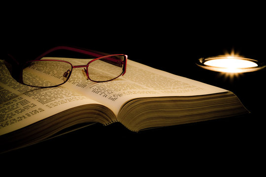 Book, glases and candle
