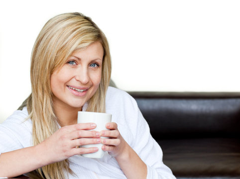 Self-assured woman holding a cup of coffee