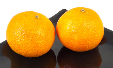 two oranges on plate isolated on white background
