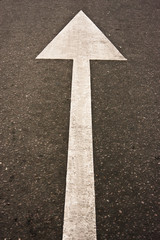 White arrow on asphalt