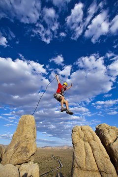 Climber jumping across gap.