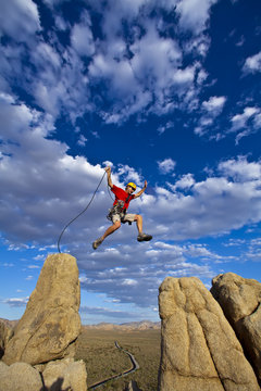 Climber jumping across gap.