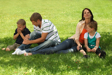family having a break below a tree