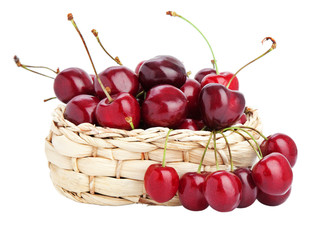 sweet cherries in a basket isolated on white.