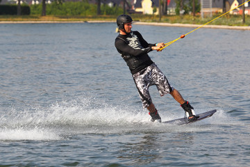 Mann auf Wakeboard beim Wassersport