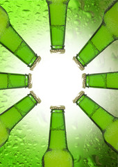 Beer bottle isolated on green background in shape of the sun