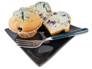 fork and muffins on black plate isolated on white