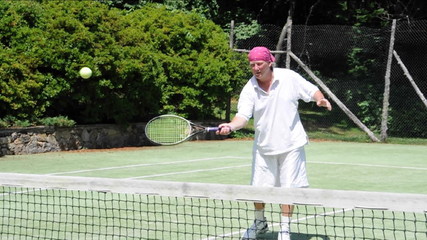 senior middle age tennis player   practicing a volley motion - Powered by Adobe