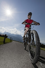 Fototapeta na wymiar Mountain biker with sun