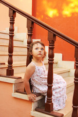 young girl sits on the stairs