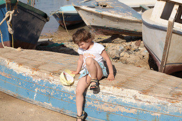 young girl sits on the boat