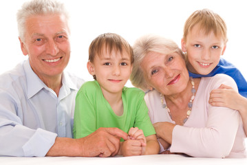 elderly couple with their grandchildren