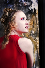 Look of hope lady in red against antique column