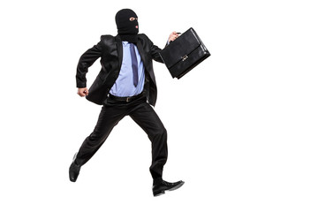Fototapeta na wymiar A burglar with robbery mask running away isolated on white