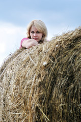 Naklejka na ściany i meble young woman and huge haystack