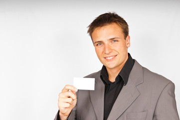 Young man in suit with business card.