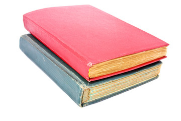 Old books piled together on white background