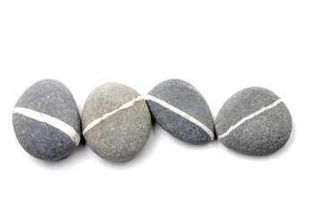 Four nature striped stones on white background