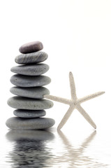 Fototapeta na wymiar Stacked zen stones with starfish