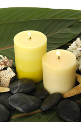 Obraz na płótnie Canvas Aromatic candles seashell and black stone in a spa