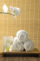 Spa towels, candles and orchid flower