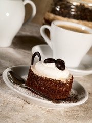 pastry on the plate with cup of espresso