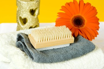 A SPA set with a red gerber and golden candle