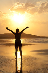 Fototapeta na wymiar woman enjoying the sun of sunset in a lonely beach