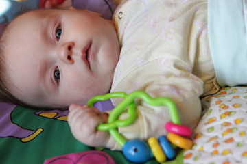 Baby with rattle