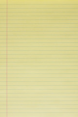 Blank yellow lined legal pad in portrait orientation. © jhamlon