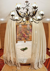 Medieval style bedroom with canopy bed on wide angle view