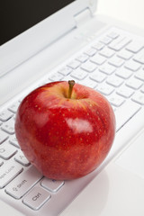 Computer Keyboard and red apple