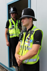 Two British Police Constables in uniform standing together