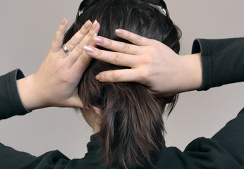 Female hands and head from back