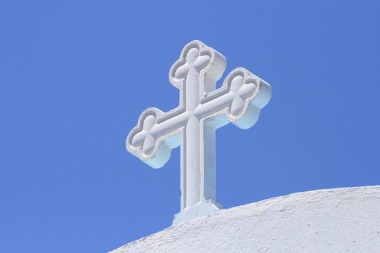 white cross under blue sky - Powered by Adobe