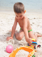 boy playing in the sand