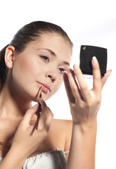 Portrait of beautiful woman applying lipstick using lip conceale