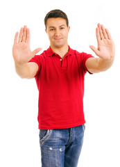 Fototapeta premium young man making stop with his hands, isolated on white