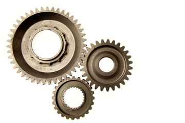 Three steel metal cog gears isolated on white