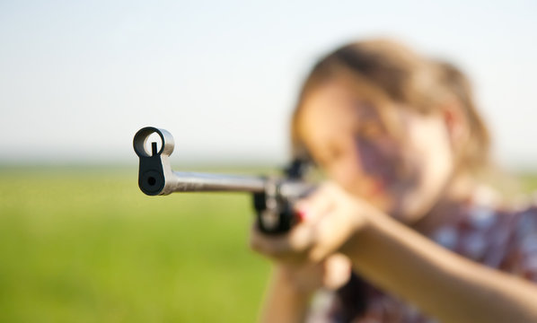 girl  aiming a pneumatic rifle