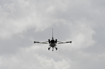 military jet silhouette against a cloudy sky
