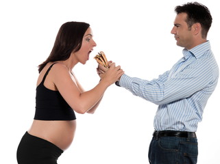 Couple expecting baby eating hamburger