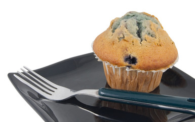 muffin and fork on white background