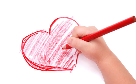Fototapeta Childrens hand with pencil draws the heart