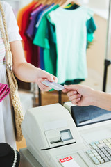 Obraz premium Close-up of a cute woman paying with her credit card