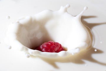 raspberry falls into milk