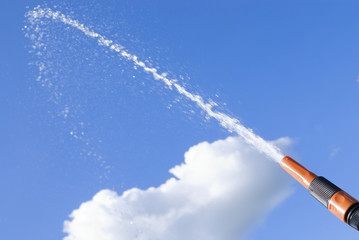 Water in the sky splashes from the hose