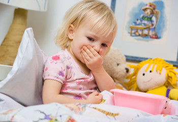 little sick girl in bed with bowl © mbt_studio