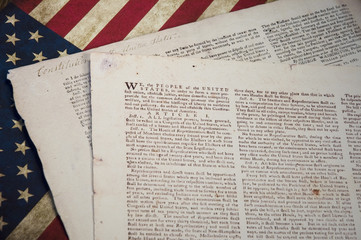 US Constitution with a US flag background