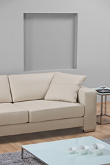 A modern minimalist living-room with white leather furniture